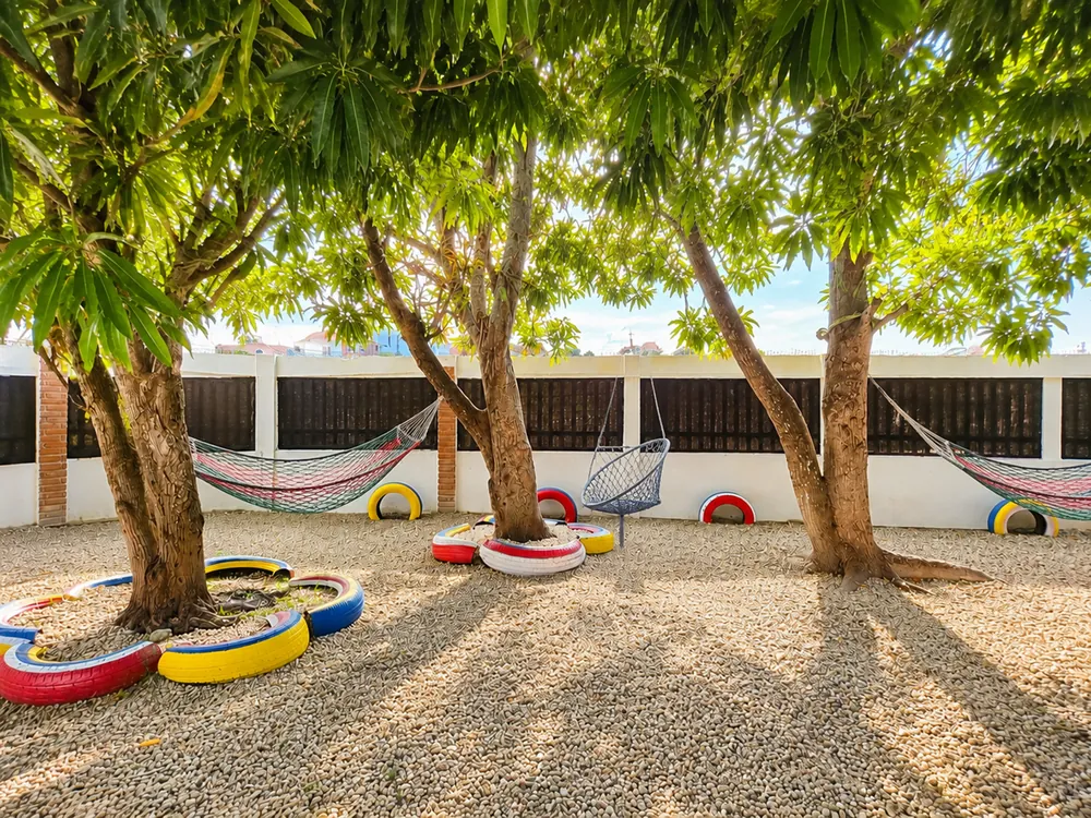 Hammocks and tyre swings strung between the garden trees