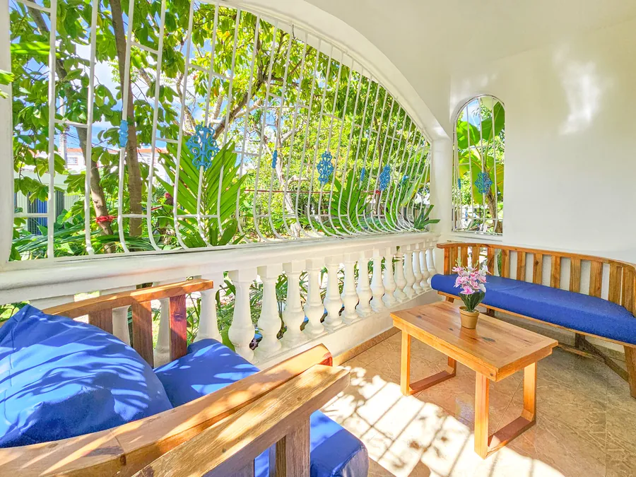 The corner terrace, blue benches and an arched balustrade