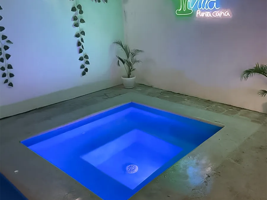 The jacuzzi at night, under the villa's neon sign