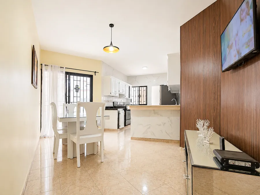 The dining area and the panelled television wall
