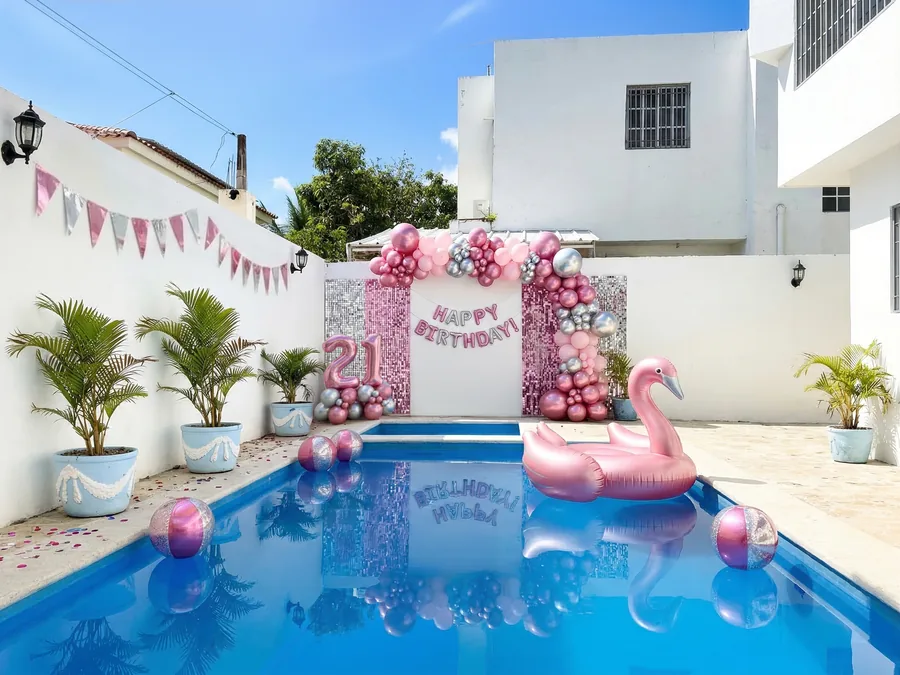 The pool dressed for a twenty-first birthday, with a balloon arch and a flamingo float