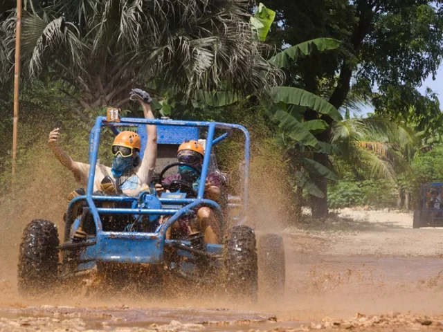 A buggy throwing up mud on a dirt track