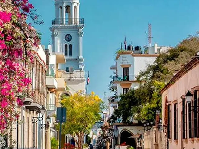 A colonial street in Santo Domingo, with bougainvillea and a bell tower